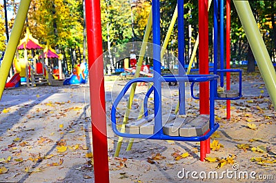 Empty playground with carousels and swings on a warm sunny autumn day Stock Photo