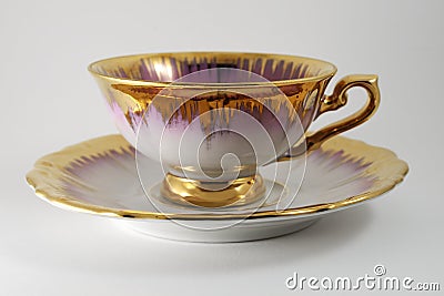 Empty porcelain tea cup with gilding on a white backdrop Stock Photo