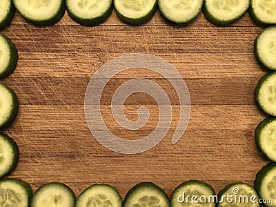 Empty postcard or frame with slides cucumbers, note paper on wooden background Stock Photo