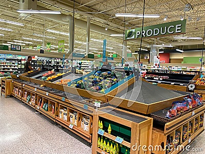 Empty produce department shelves at a Publix grocery store due to the people panicing and hoarding paper and food products Editorial Stock Photo