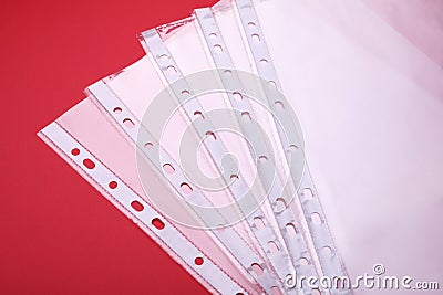 Empty punched pockets on red background, above view Stock Photo