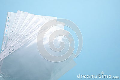 Empty punched pockets on turquoise background, flat lay. Space for text Stock Photo