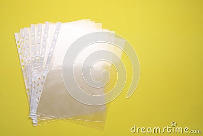 Empty punched pockets on yellow background, flat lay. Space for text Stock Photo