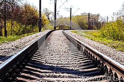 Empty Railroad Tracks Running In Forest at sunny summer day Stock Photo