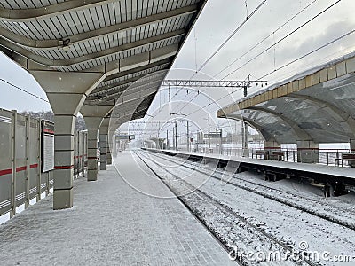 Empty railway platform without passengers in winter at the sunset. Editorial Stock Photo