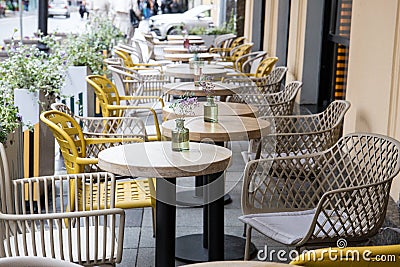 Empty restaurant tables are waiting for customers on the outdoor terrace Stock Photo