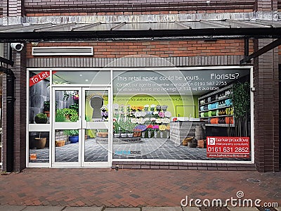 Empty retail shop unit with to let fake window display in high street setting Editorial Stock Photo