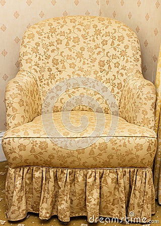 Empty retro brown armchair with floral pattern Stock Photo