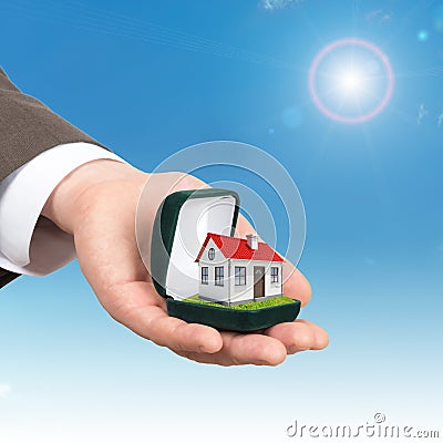 Empty ring box with house in man hand Stock Photo