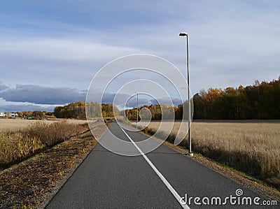 Empty road amidst field against sky Stock Photo