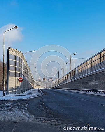 Empty road junction with fences in the city. The winter. The first snow Stock Photo