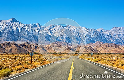 Empty road near Lone Pine with rocks of the Alabama Hills and the Sierra Nevada in the background, Inyo County, California, United Stock Photo