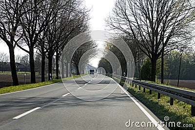 Empty road with trees Driving from Olfen to Dorsten road tripp backgrounds wallpapers in high quality fine art prints. Driving Stock Photo
