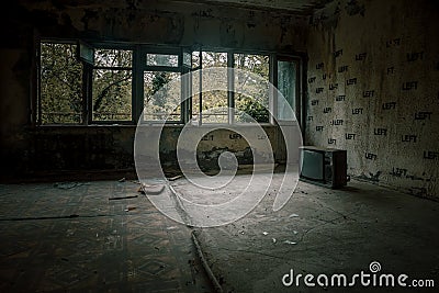Empty room in an abandoned building. Soviet architecture. Light in the window. Beautiful shadows. Stock Photo