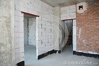 Empty room interior build with white and red bricks, plastering wall, waterproofing floor, metal door lintel Stock Photo