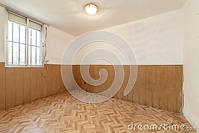 Empty room with parquet-like sintasol floor and walls covered Stock Photo
