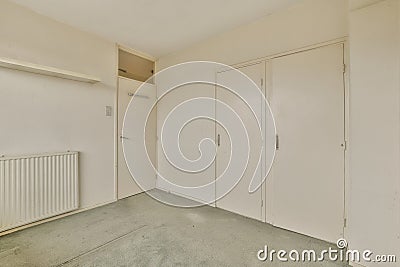 an empty room with white walls and white closets Stock Photo