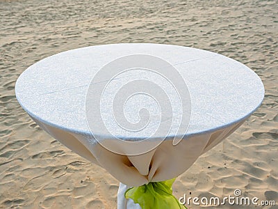 Empty round dining table with white tablecloth and light green bow Stock Photo