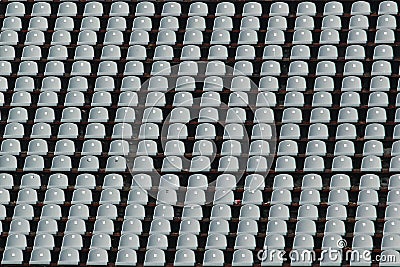 Empty rows of gray stadium seats Stock Photo
