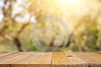 Empty rustic table in front of green spring abstract bokeh background. product display and picnic concept. Stock Photo
