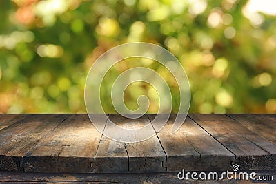 Empty rustic table in front of green spring abstract bokeh background. product display and picnic concept. Stock Photo