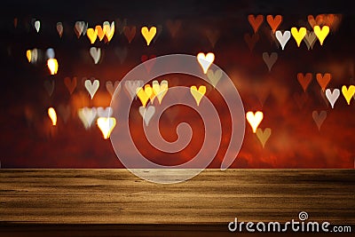 Empty rustic table in front of Valentine& x27;s day romantic glitter bokeh background with many hearts lights Stock Photo