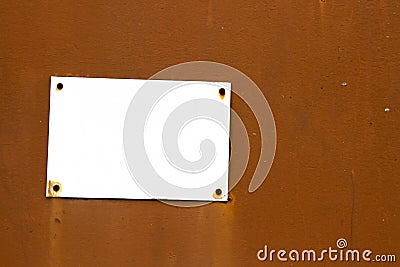 Empty rusty and grungy white signboard in rectangular shape weathered under the elements Stock Photo