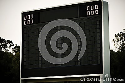 empty scoreboard for sports against a background of the sky and treetops Stock Photo
