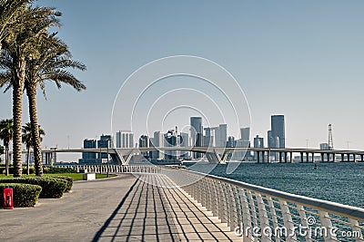 Empty seafront with the skyline view of Abu Dhabi city with high-rise buildings in the background Stock Photo