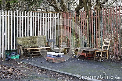 Empty seats and table in smoking area outside work factory Stock Photo