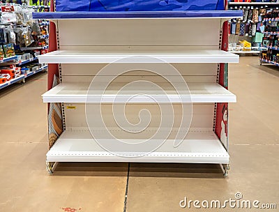 Empty shelves in the store. Laying out goods in a supermarket Stock Photo