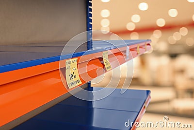 Empty shelves in supermarket, closeup. Product deficiency due to social panic Stock Photo