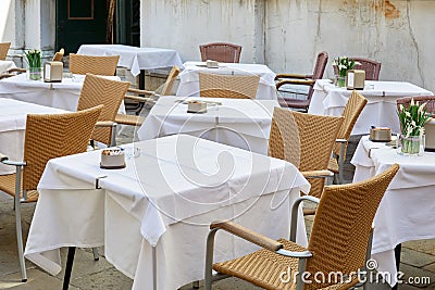 Empty sidewalk tables and chairs in a sunny morning Stock Photo