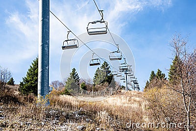 Empty ski lift over a lush hillside Stock Photo