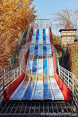 an empty slide in the autumn park Stock Photo