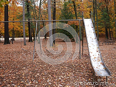 Empty slide in the park during the fall Stock Photo