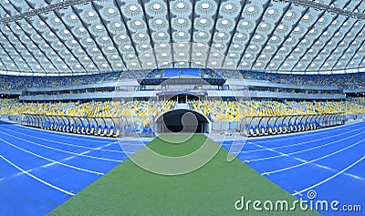 Empty soccer field of the stadium, tunnel from where football players come out, seats for trainers substitute players Editorial Stock Photo