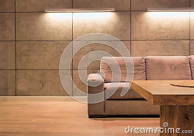 Empty sofa against illuminated wall in apartment Stock Photo