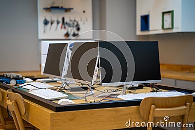 Empty software developer office workplace with a desk with multiple computer screen Stock Photo