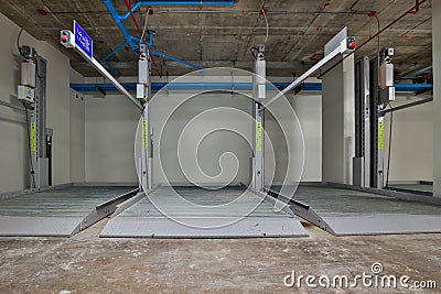 Empty Space in Automatic Elevator double stack car park. Hydraulic lift. Empty garage. Hydraulic machine for lifting car indoor pa Stock Photo