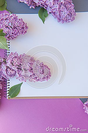Empty space notepad list with lilac bunch of flowers, cute spring vertical banner Stock Photo