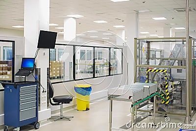 Special room in the scientific laboratory with a technological line for the production and packaging of medical preparations. Stock Photo