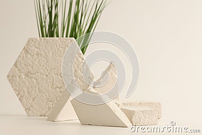 Empty stack of gypsum stones platform podium and grass on beige background. Minimal empty display product presentation scene Stock Photo