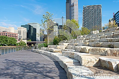 Stone Seating on the Riverwalk along the South Branch of the Chicago River in Downtown Chicago with Skyscrapers Stock Photo
