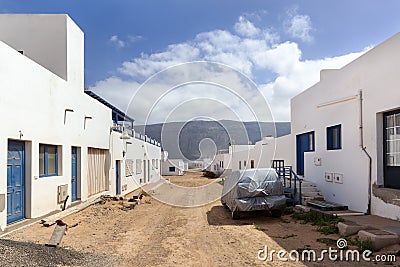 Empty street with sand and white houses in Caleta de Sebo on the island La Graciosa Stock Photo