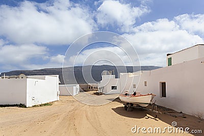 Empty street with sand and white houses in Caleta de Sebo on the island La Graciosa Stock Photo