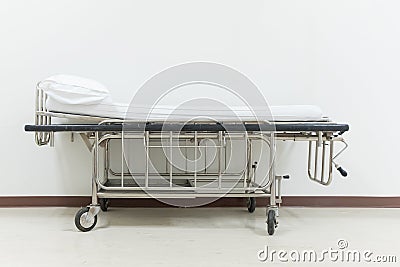 Empty stretcher trolley or hospital trolley for patient with white room. Stock Photo