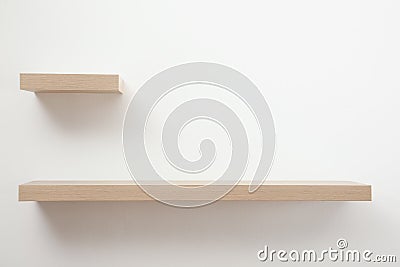 Empty stylish wooden shelves on light wall Stock Photo