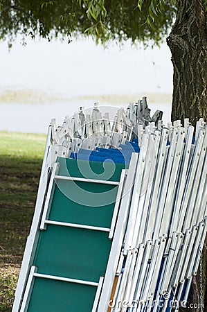 Empty sunbeds in line at the lake Stock Photo