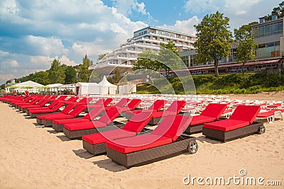 Empty sunbeds in a row on the sand beach Stock Photo